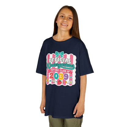 Girl wearing a navy TEEZOCA coquette Official Kindergartener Future Class of 2039 kids tee, a cute first-day-of-school keepsake shirt.

