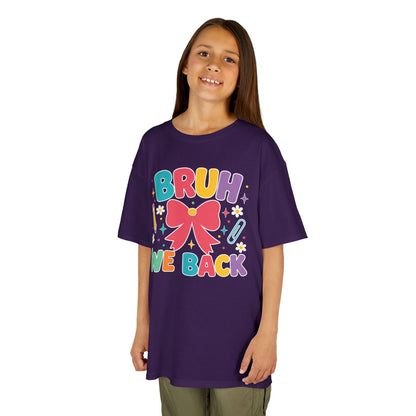 Girl wearing a purple TEEZOCA Bruh We Back coquette kids tee with a bow, a cute funny back to school shirt.
