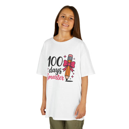 Girl wearing a white TEEZOCA “100 Days Smarter” pink bow pencil milestone t‑shirt.