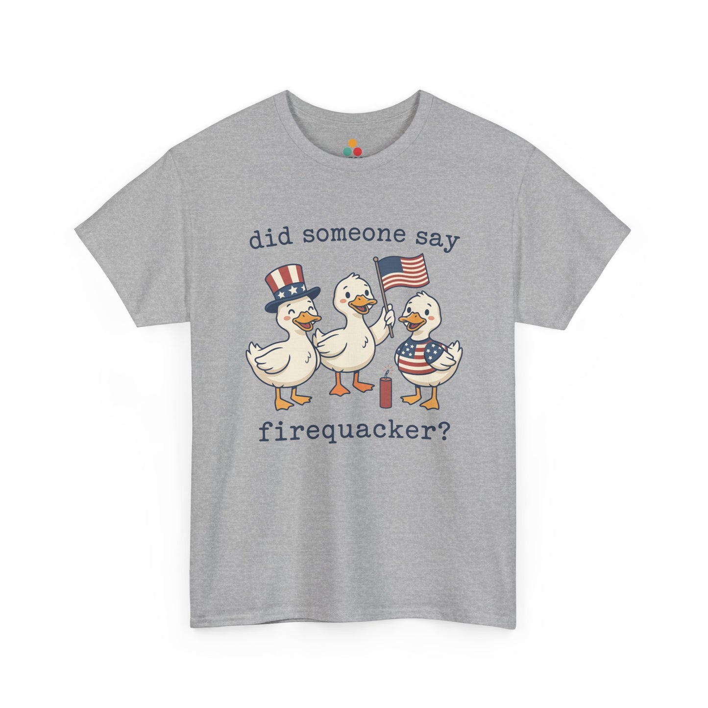 Gray TEEZOCA T-shirt featuring three cartoon patriotic ducks — one in an Uncle Sam hat, one holding a US flag, and one in a stars-and-stripes outfit — around a firecracker with the text "did someone say firequacker?" printed above and below.

