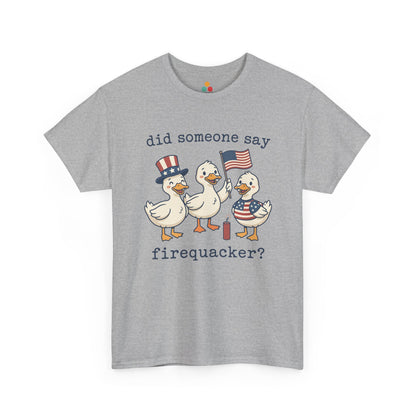 Gray TEEZOCA T-shirt featuring three cartoon patriotic ducks — one in an Uncle Sam hat, one holding a US flag, and one in a stars-and-stripes outfit — around a firecracker with the text "did someone say firequacker?" printed above and below.


