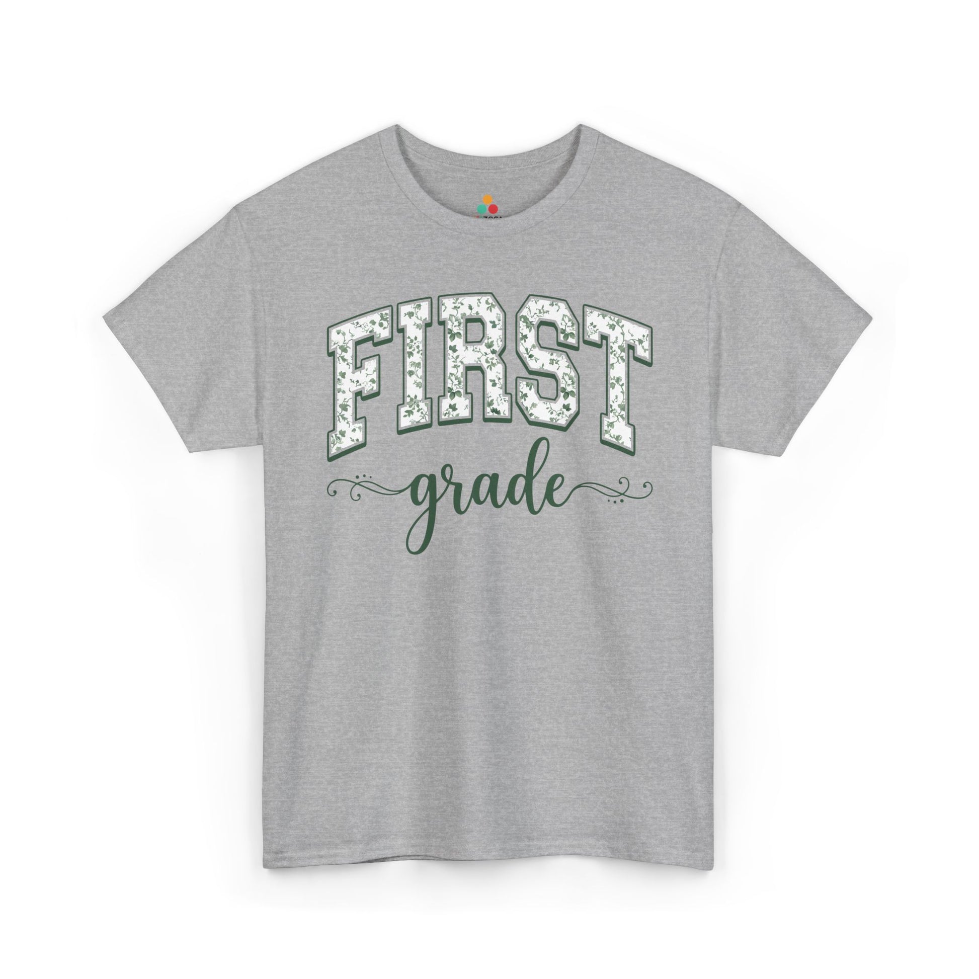 Gray t-shirt with 'FIRST grade' text on a white background. Cute first grade shirt from TEEZOCA, a unisex adult tee worn by teachers, aides, and room parents.
