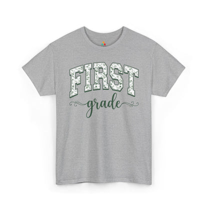 Gray t-shirt with 'FIRST grade' text on a white background. Cute first grade shirt from TEEZOCA, a unisex adult tee worn by teachers, aides, and room parents.
