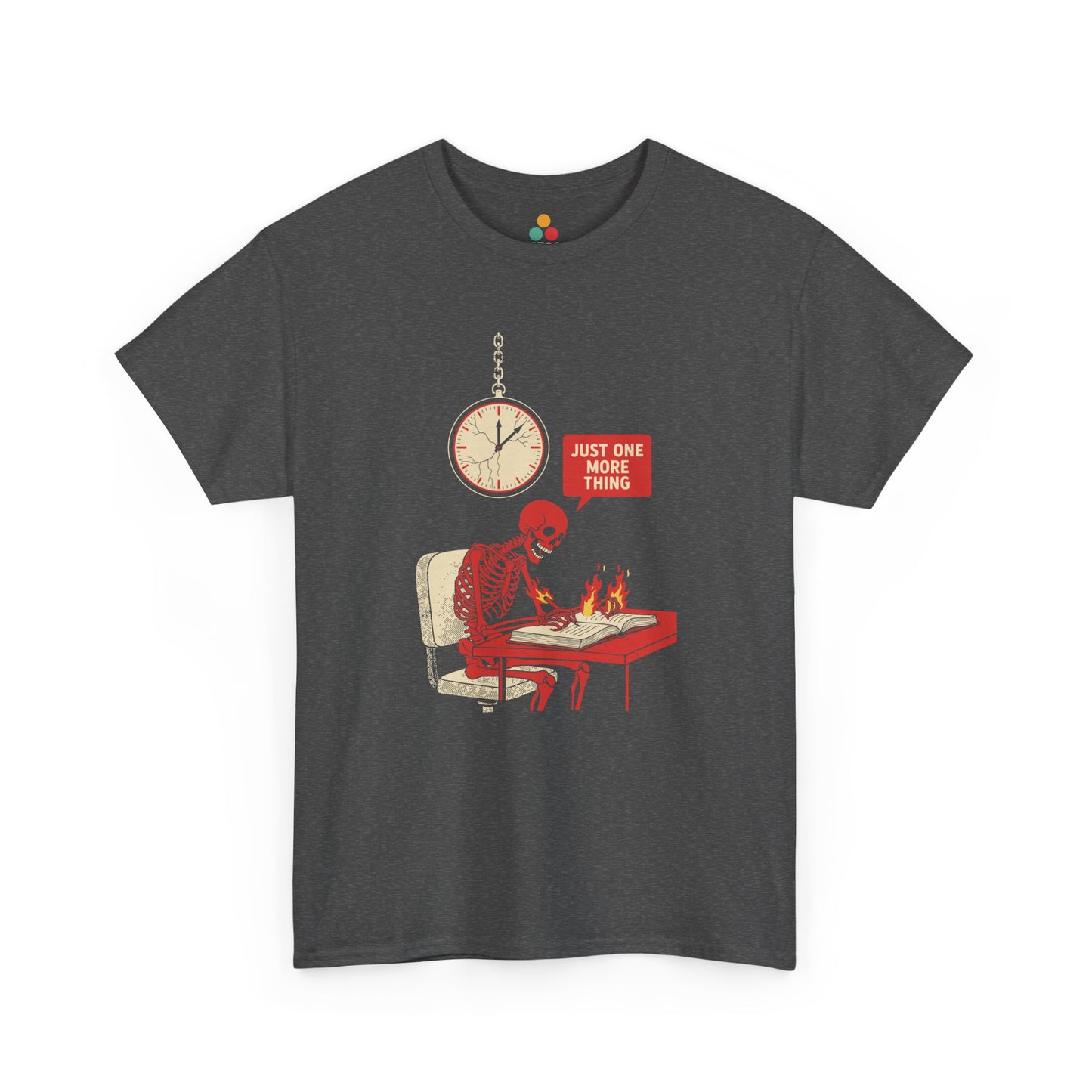 Gray t‑shirt featuring a red skeleton sitting at a desk with hands on fire, writing in a book under a wall clock, with a speech bubble saying “Just One More Thing.”

