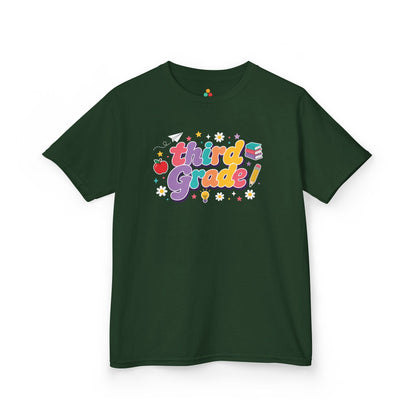 Green t-shirt with 'third Grade!' text and graphics on a white background. TEEZOCA t-shirt with rainbow school lettering for parents browsing a 3rd Grade Shirt for Girls.