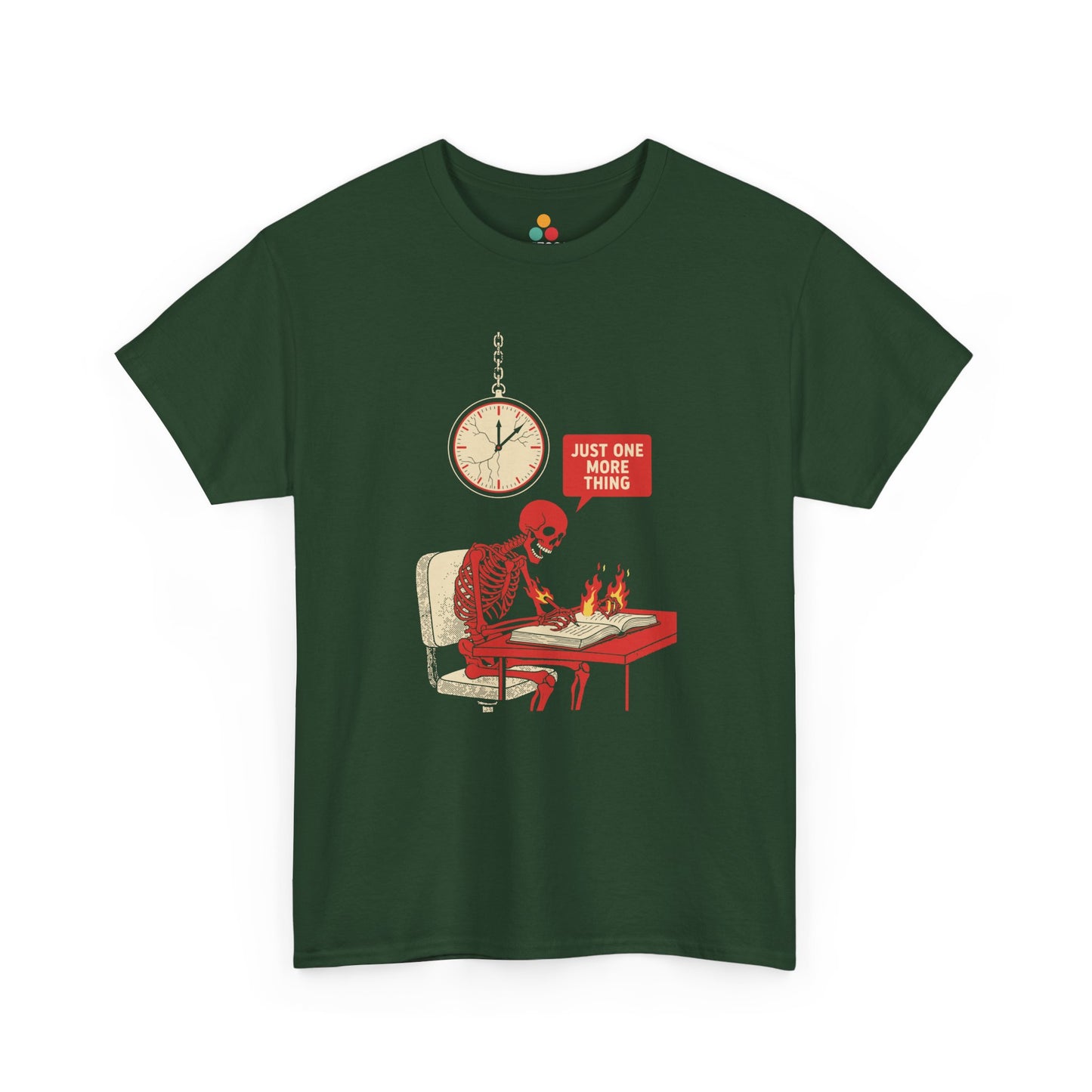 Green t‑shirt featuring a red skeleton sitting at a desk with hands on fire, writing in a book under a wall clock, with a speech bubble saying “Just One More Thing.”
