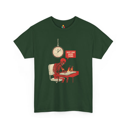 Green t‑shirt featuring a red skeleton sitting at a desk with hands on fire, writing in a book under a wall clock, with a speech bubble saying “Just One More Thing.”
