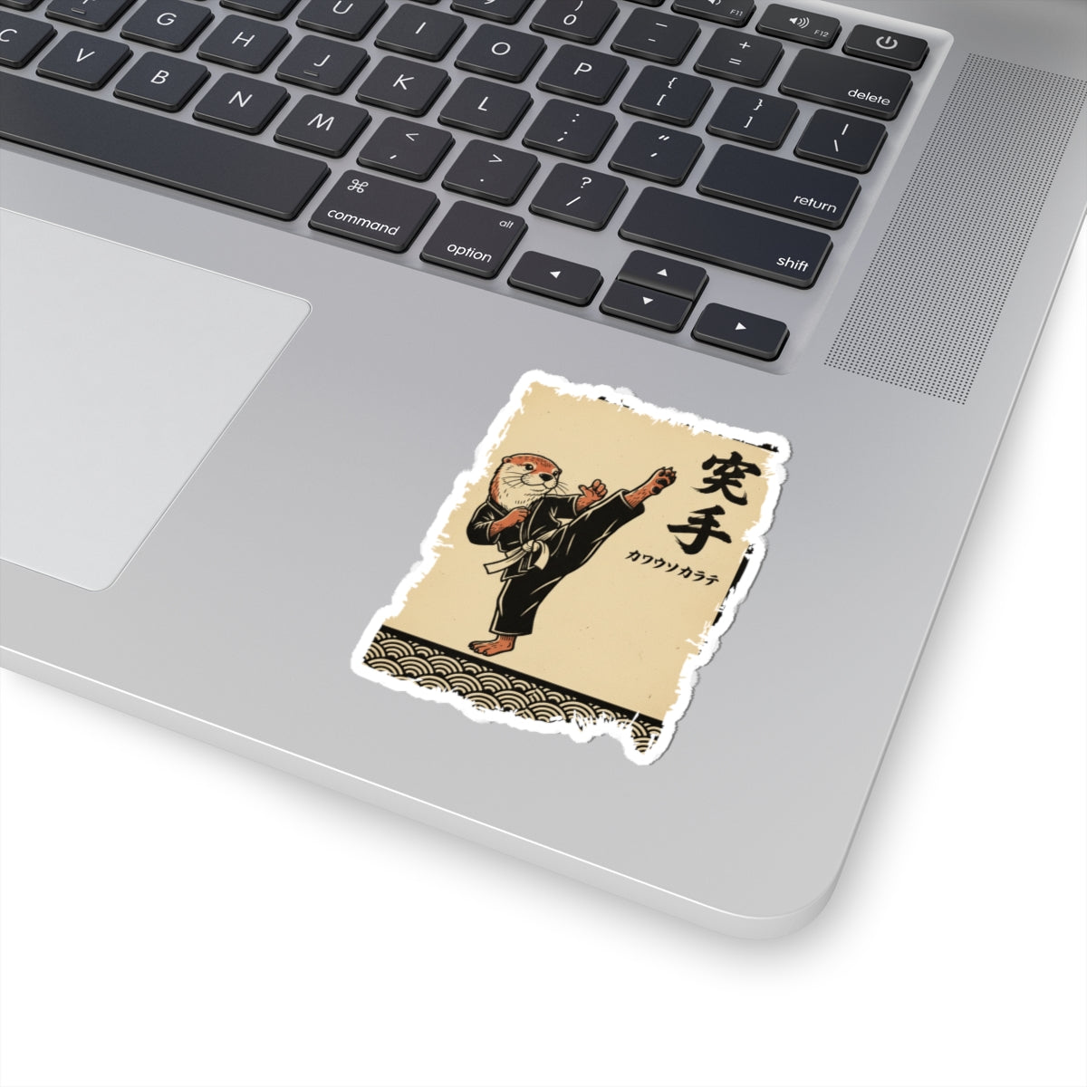 Laptop with a sticker of a character in a traditional outfit on the palm rest area.