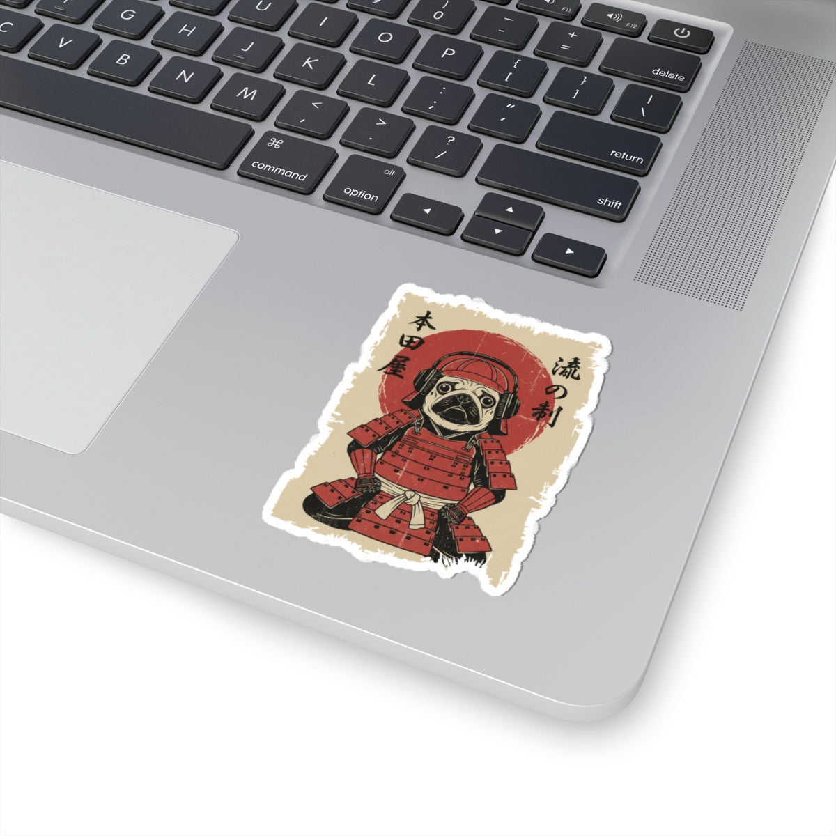 Laptop with a sticker of a character in red armor on a white surface