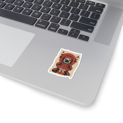 Laptop with a sticker of a dog in a red outfit on a white surface