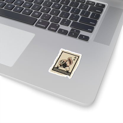 Laptop with a sticker of a raccoon on a white surface