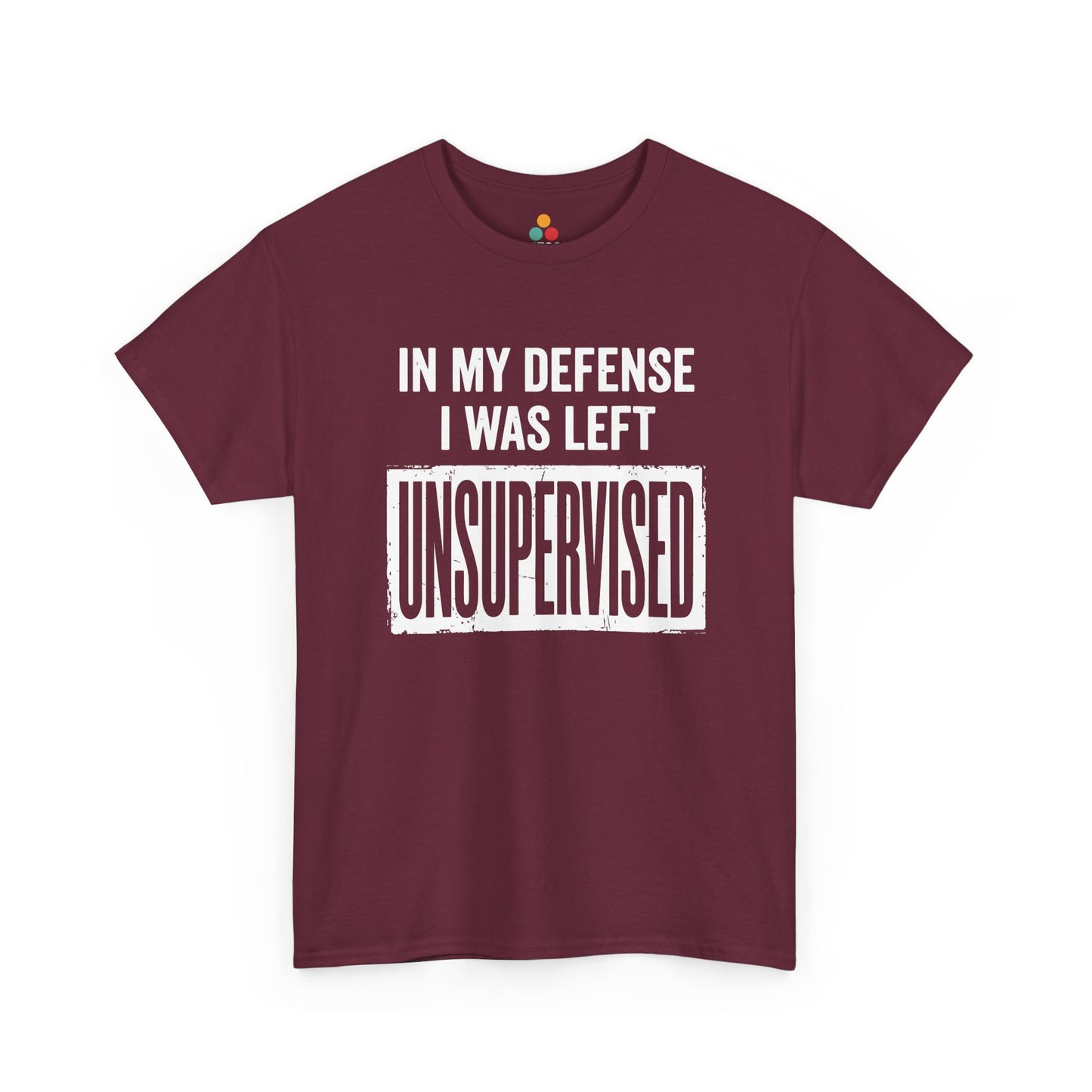 Maroon T-shirt featuring bold white block typography reading "In My Defense I Was Left Unsupervised" with a highlighted "UNSUPERVISED" text box, funny sarcastic quote shirt, witty statement tee, dry humor graphic tee, and bold novelty quote apparel.