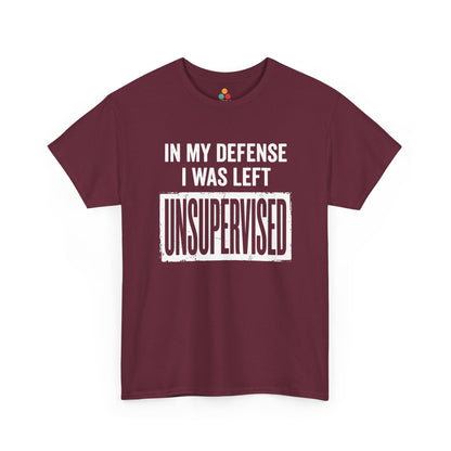 Maroon T-shirt featuring bold white block typography reading "In My Defense I Was Left Unsupervised" with a highlighted "UNSUPERVISED" text box, funny sarcastic quote shirt, witty statement tee, dry humor graphic tee, and bold novelty quote apparel.