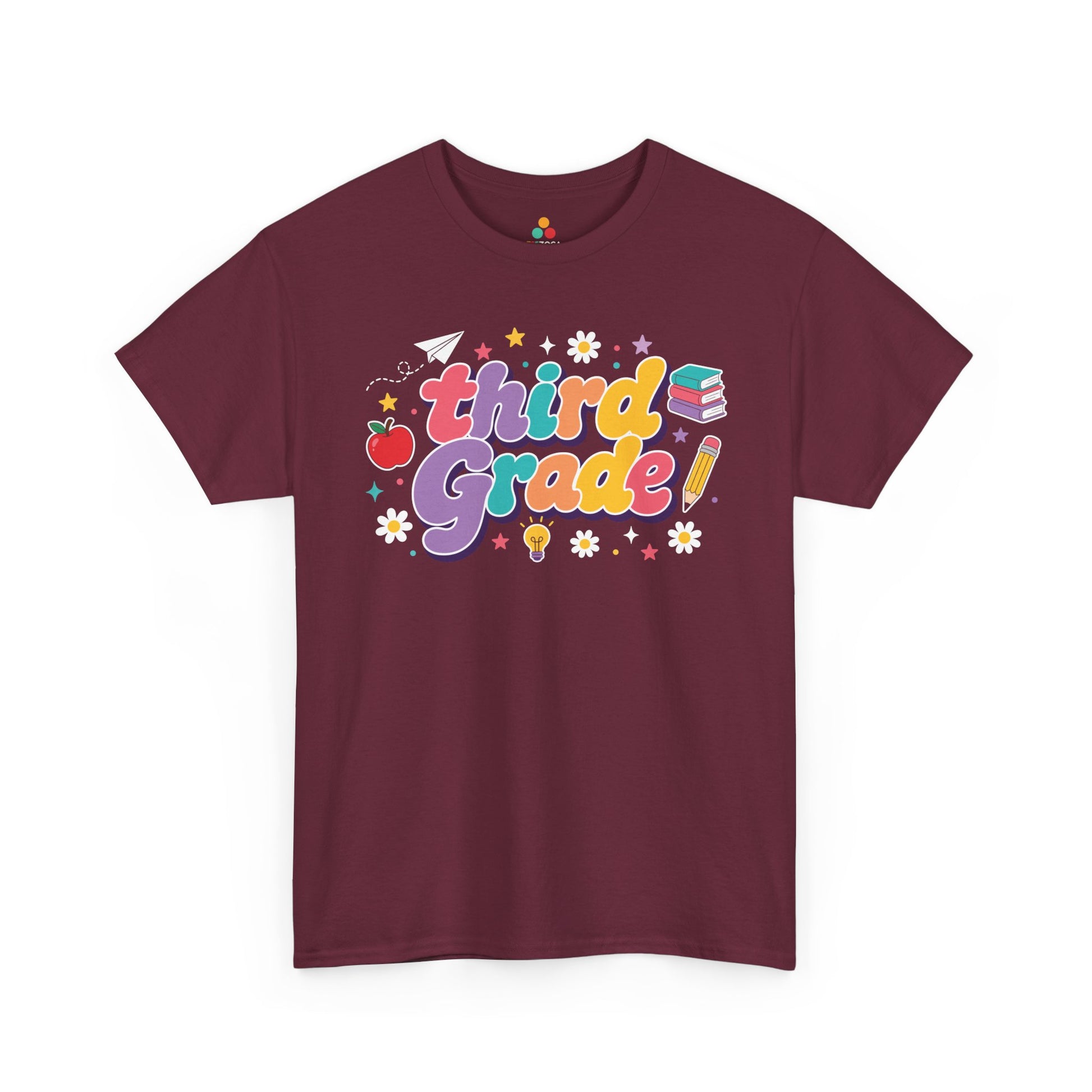 Maroon t-shirt with 'third grade!' text and educational graphics on a white background. TEEZOCA t-shirt pairs bold “Third Grade” text with an apple, books, a pencil, and a light bulb for matching third grade teacher squad shirts.