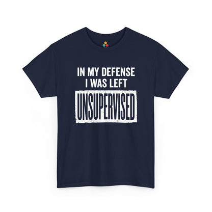 Navy T-shirt featuring bold white block typography reading "In My Defense I Was Left Unsupervised" with a highlighted "UNSUPERVISED" text box, funny sarcastic quote shirt, witty statement tee, dry humor graphic tee, and bold novelty quote apparel.