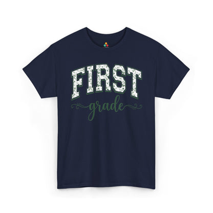 Navy blue t-shirt with 'FIRST grade' text on a white background. Matching first grade shirt by TEEZOCA in sage florals, worn by an adult alongside a new first grader on the first day of school.
