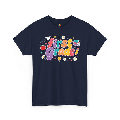 Navy blue t-shirt with 'first Grade!' text and educational graphics on a white background. TEEZOCA t-shirt featuring oversized retro “First Grade” bubble lettering, deep purple shadows, school icons, and colorful stars for a first grade teacher shirt.