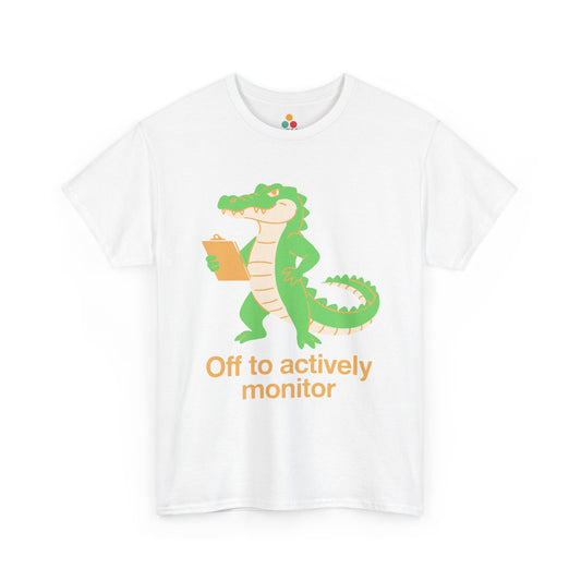 Off to Actively Monitor Funny Test Day School Crocodile T-Shirt – State Testing Gift for Teachers | TEEZOCA Unisex T-shirt with Funny Science Teacher Shirt Off to Actively Monitor design, featuring a green alligator holding a clipboard.
