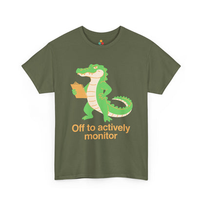 Off to Actively Monitor Funny Test Day School Crocodile T-Shirt – State Testing Gift for Teachers | TEEZOCA t-shirt featuring Funny Science Teacher Shirt Off to Actively Monitor artwork with orange lettering, sparkles, and reptile humor.
