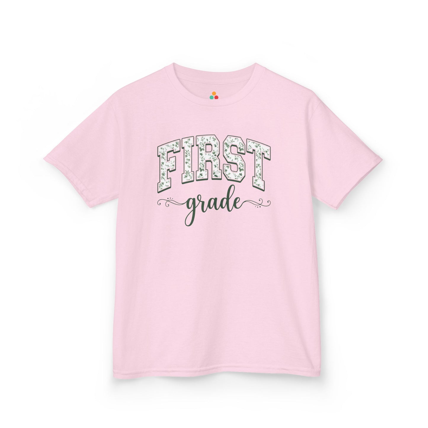 Pink t-shirt with 'FIRST grade' text on a white background. Purple t-shirt. TEEZOCA floral back to school tee for kids in first grade, a first-day pick parents find on Amazon and Etsy for class photos.