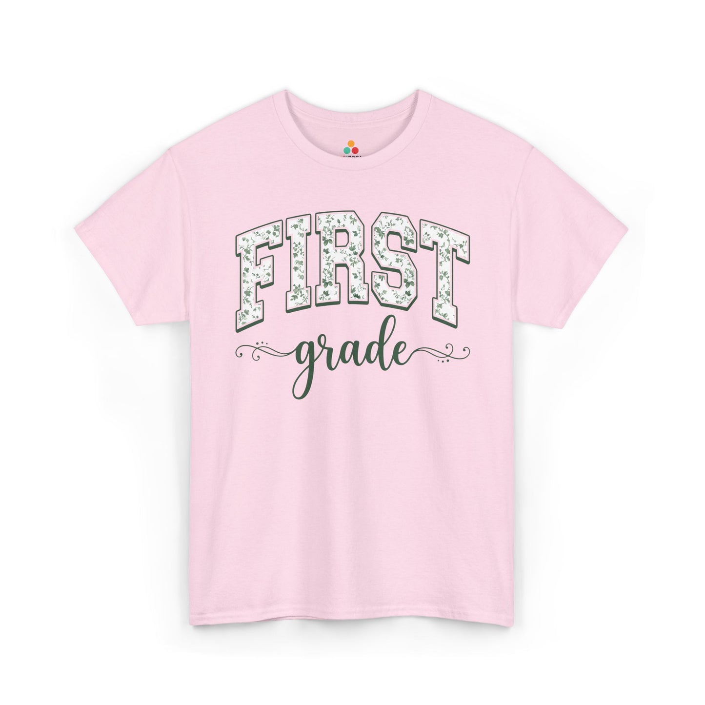 Pink t-shirt with 'FIRST grade' text on a white background. TEEZOCA first grade teacher shirt featuring sage floral varsity lettering, a cute back to school tee for teachers.
