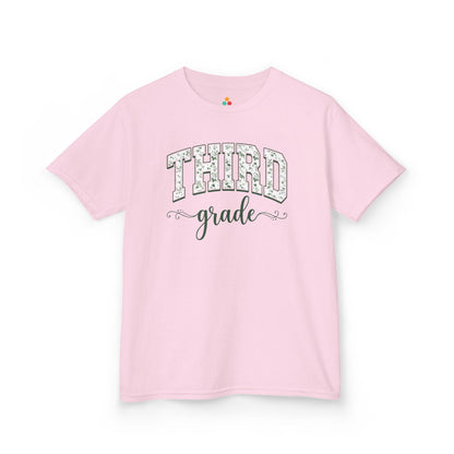 Pink t-shirt with 'THIRD grade' text on a white background. TEEZOCA floral back to school tee for kids in third grade, a first-day pick parents find on Amazon and Etsy for class photos.

