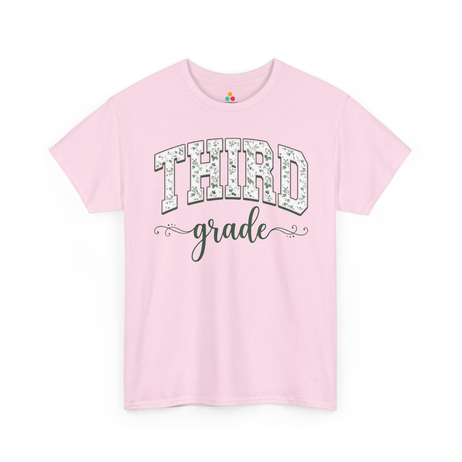 Pink t-shirt with 'THIRD grade' text on a white background. TEEZOCA third grade teacher shirt featuring sage floral varsity lettering, a cute back to school tee for teachers.
