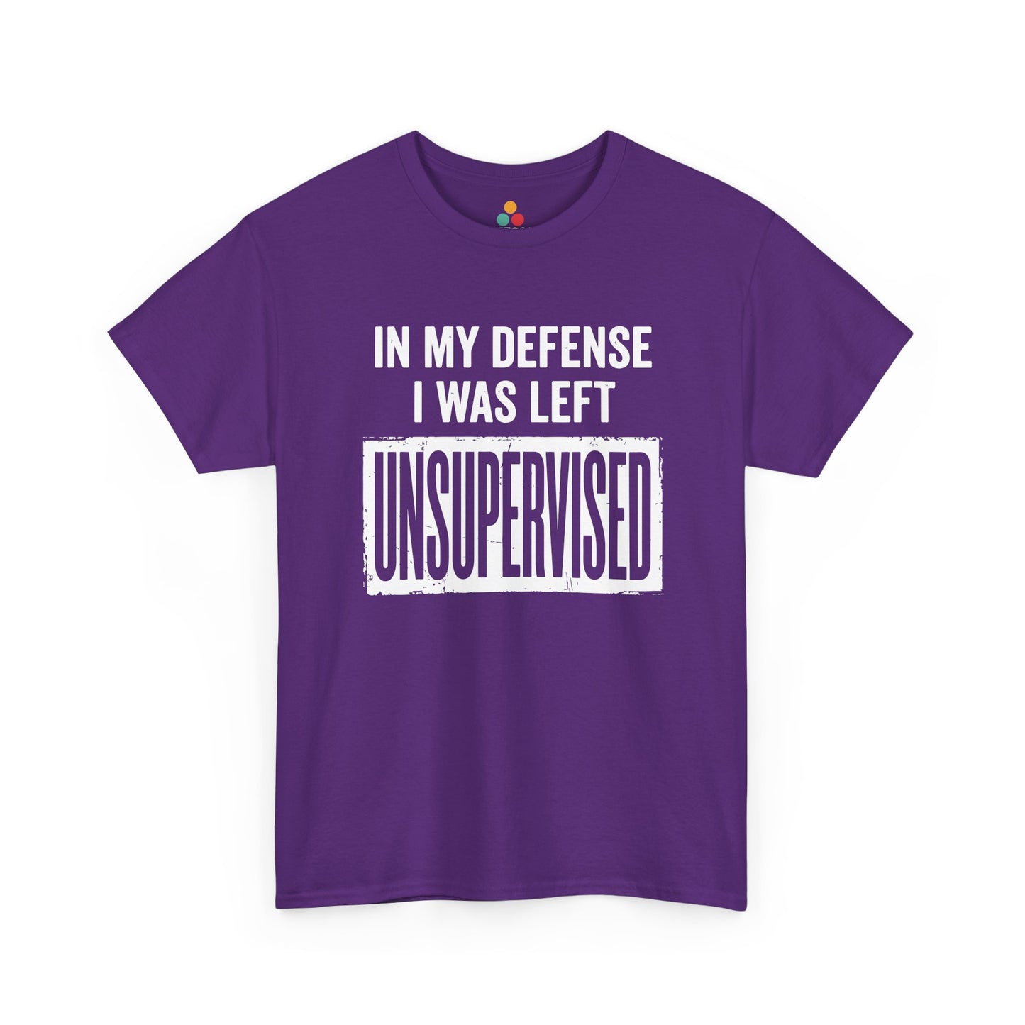 Purple T-shirt featuring bold white block typography reading "In My Defense I Was Left Unsupervised" with a highlighted "UNSUPERVISED" text box, funny sarcastic quote shirt, witty statement tee, dry humor graphic tee, and bold novelty quote apparel.