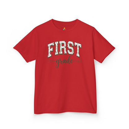 Red t-shirt with a graphic text design on a white background. Floral first grade kids tee from TEEZOCA reading first grade in arched varsity type, a cute back to school shirt.
