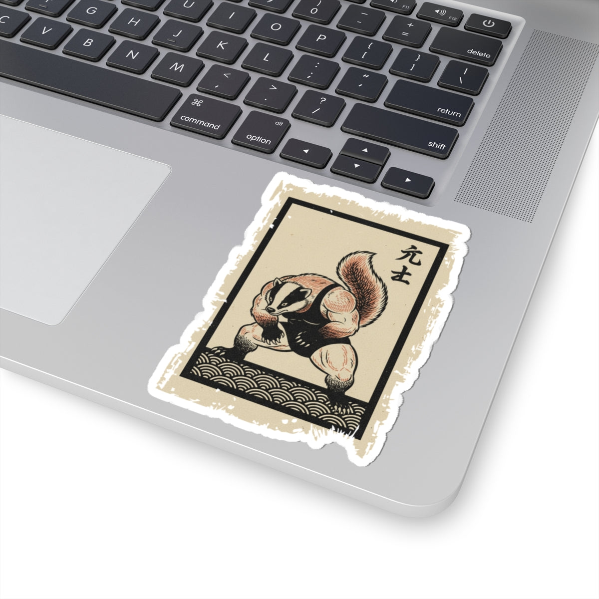 Sticker of a badger in a martial arts pose on a laptop