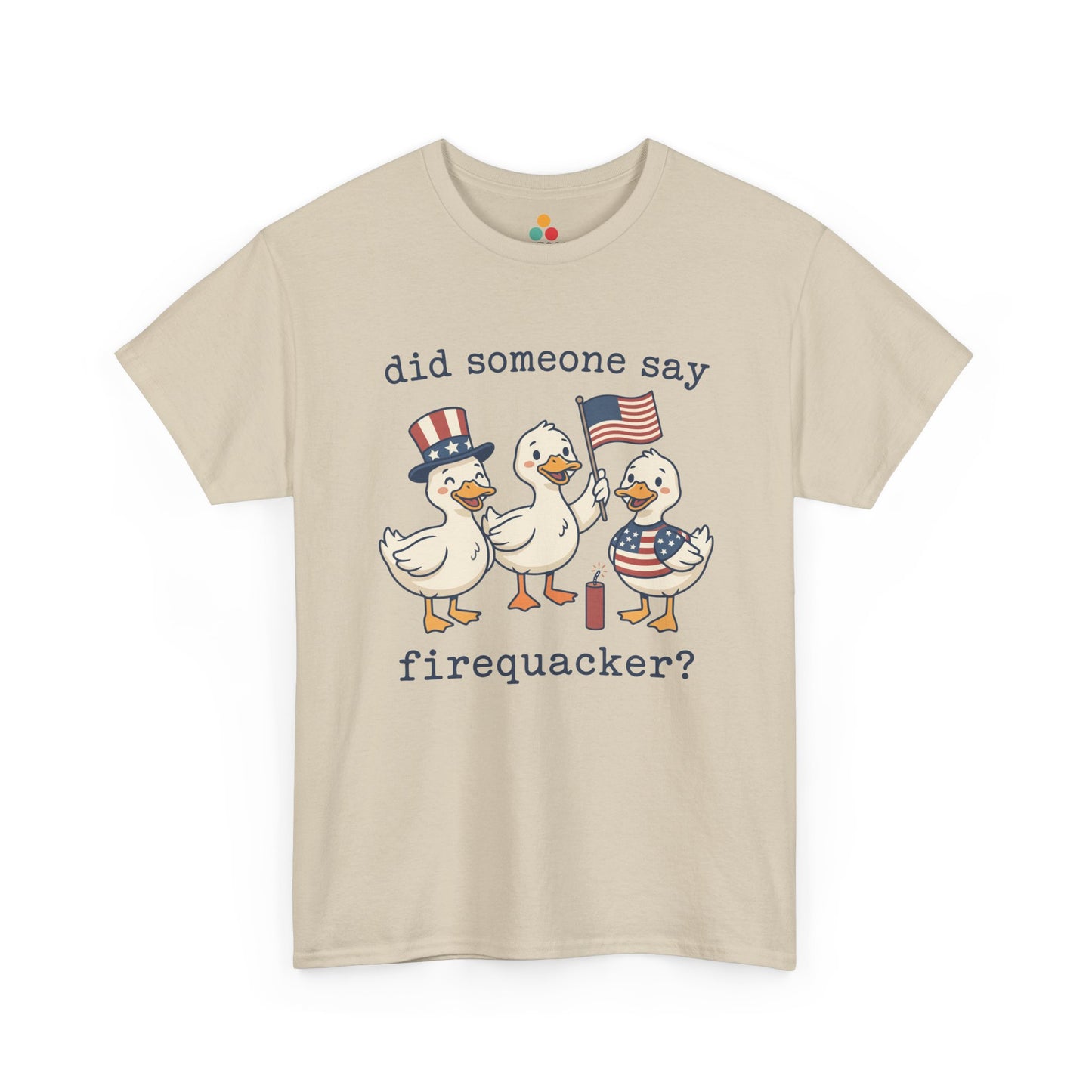 beige  TEEZOCA T-shirt featuring three cartoon patriotic ducks — one in an Uncle Sam hat, one holding a US flag, and one in a stars-and-stripes outfit — around a firecracker with the text "did someone say firequacker?" printed above and below.

