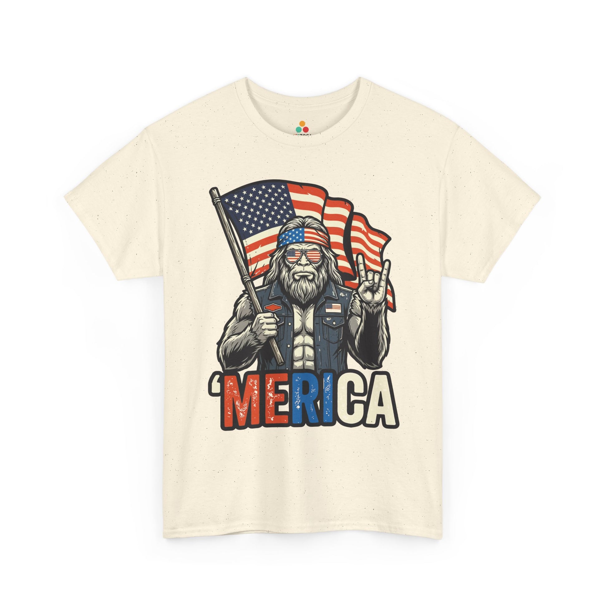 TEEZOCA 4th of July T-shirt showing Bigfoot holding an American flag with Merica lettering and rugged patriotic style.
