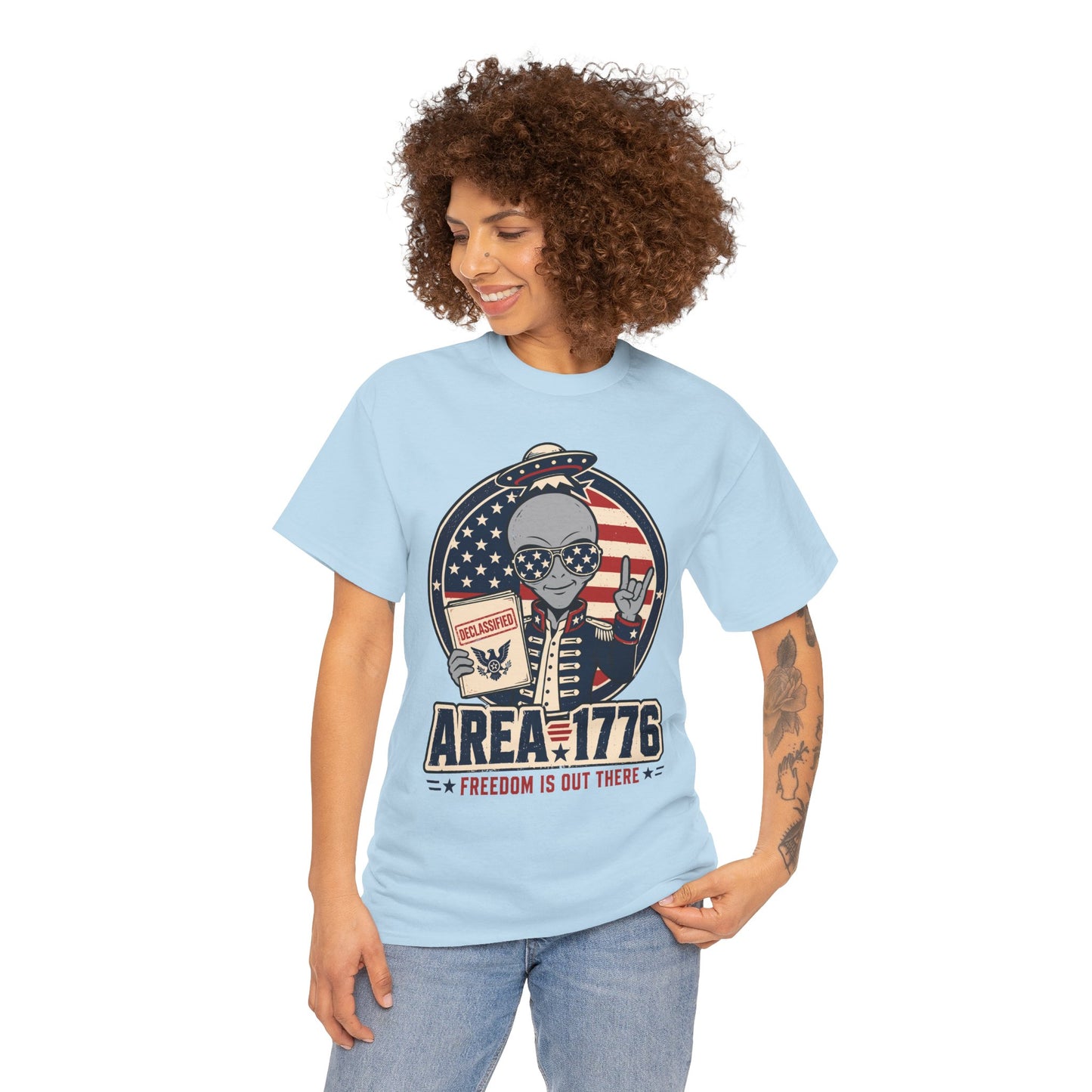 TEEZOCA Freedom Shirt T-shirt featuring an alien in patriotic sunglasses holding a declassified folder with Area 1776 text.
