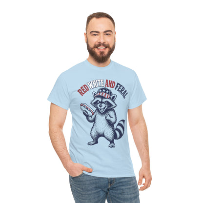 TEEZOCA Funny 4th of July Shirt t-shirt with a snarling raccoon in a flag cap holding a hot dog beneath Red White and Feral lettering.
