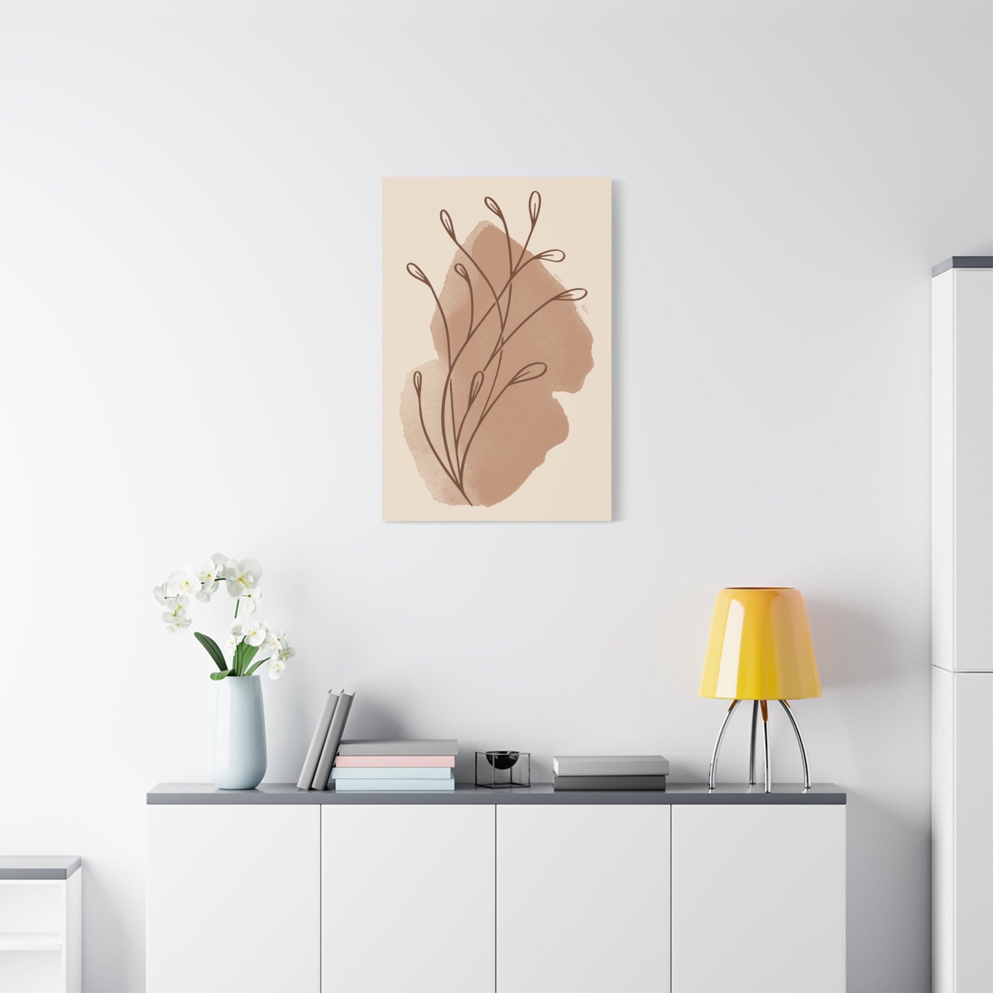 TEEZOCA abstract leaf canvas hanging above white console with lamp and decorative vase.