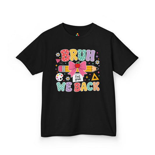 TEEZOCA black Bruh We Back First Grade kids shirt laid flat, colorful lettering with a bow-topped pencil and apple, a funny back to school tee.
