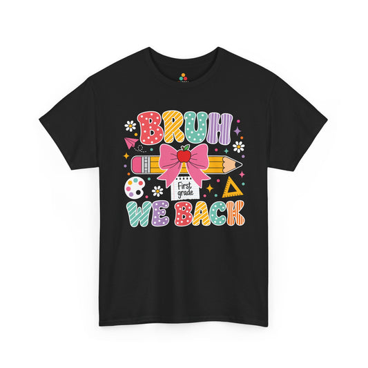 TEEZOCA black Bruh We Back First Grade shirt laid flat, colorful lettering with a bow-topped pencil and apple, a funny teacher back to school tee.
