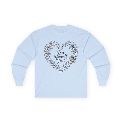 TEEZOCA elegant floral love yourself first design on unisex long-sleeve t-shirt Light blue sweatshirt with floral heart design and 'Love Yourself First' text on a white background