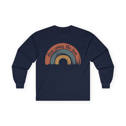 TEEZOCA here comes the sun rainbow design on unisex long-sleeve t-shirt Navy blue long-sleeve shirt with a rainbow design and 'Here comes the sun' text on a white background