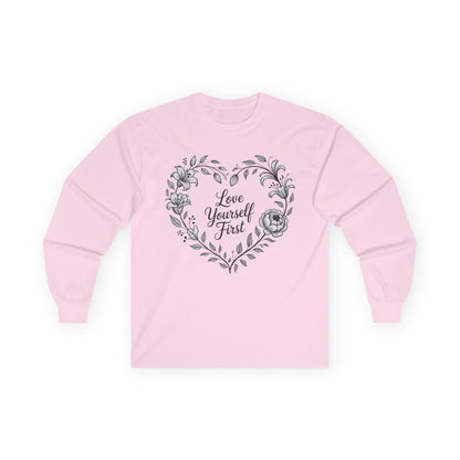 TEEZOCA love yourself first floral heart design on unisex long-sleeve t-shirt Pink sweatshirt with floral heart design and 'Love Yourself First' text on a white background