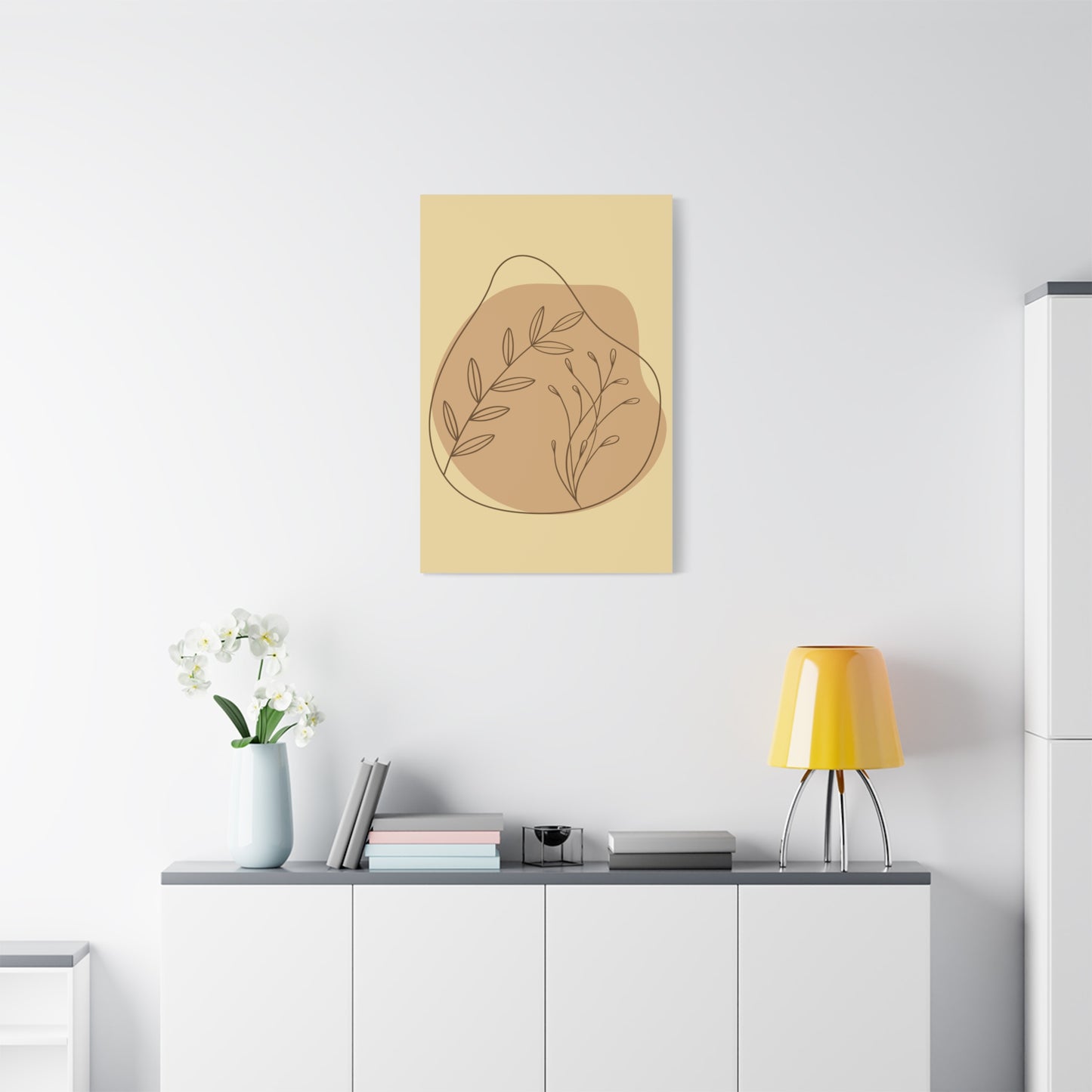 TEEZOCA minimalist boho botanical canvas on white wall next to small shelf.