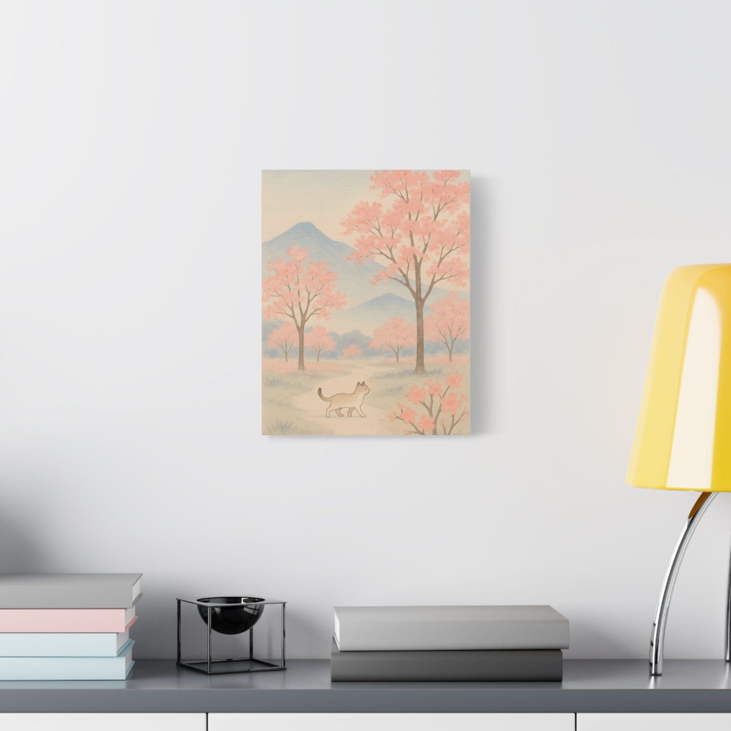 TEEZOCA pastel mountain and cherry blossom cat print hanging in a cozy home office corner.