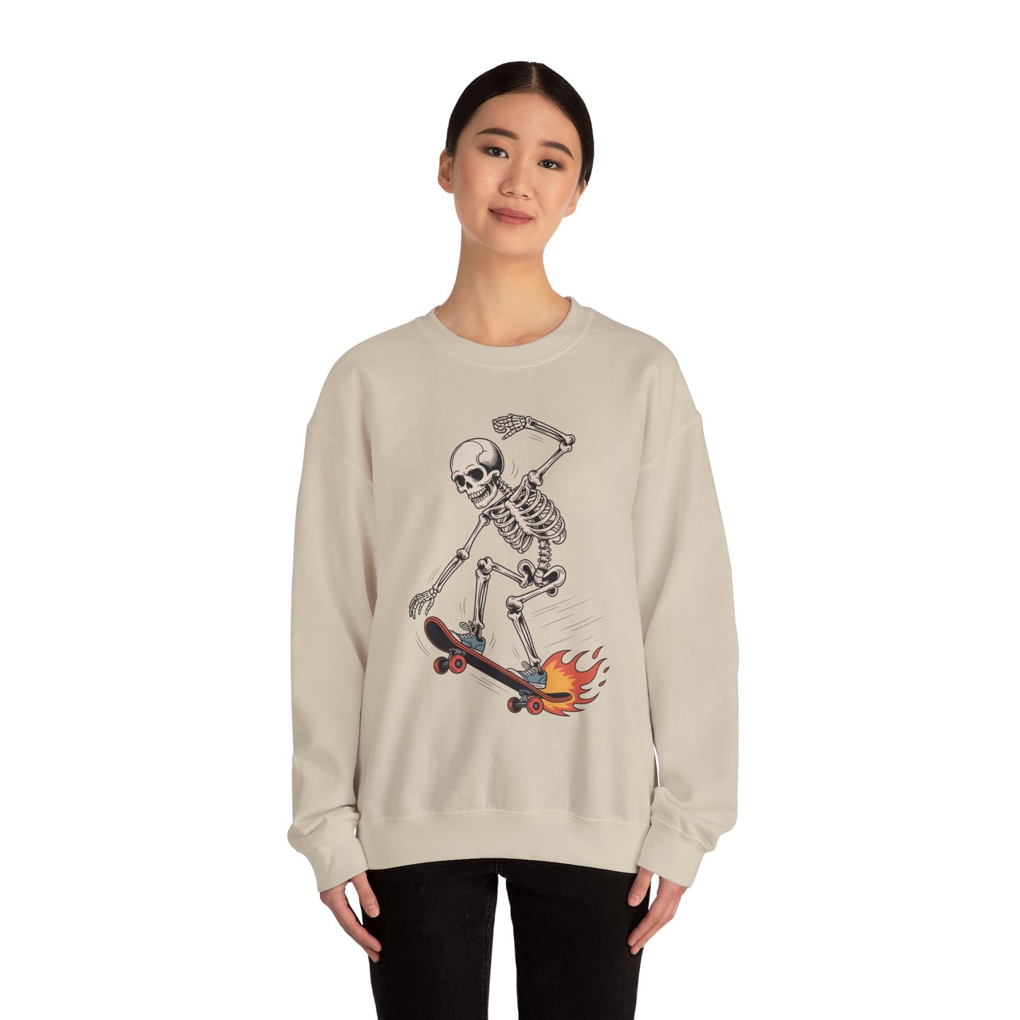 TEEZOCA skateboarding skeleton sweatshirt with flaming skateboard graphic Person wearing a beige sweatshirt with a skeleton on a skateboard design.