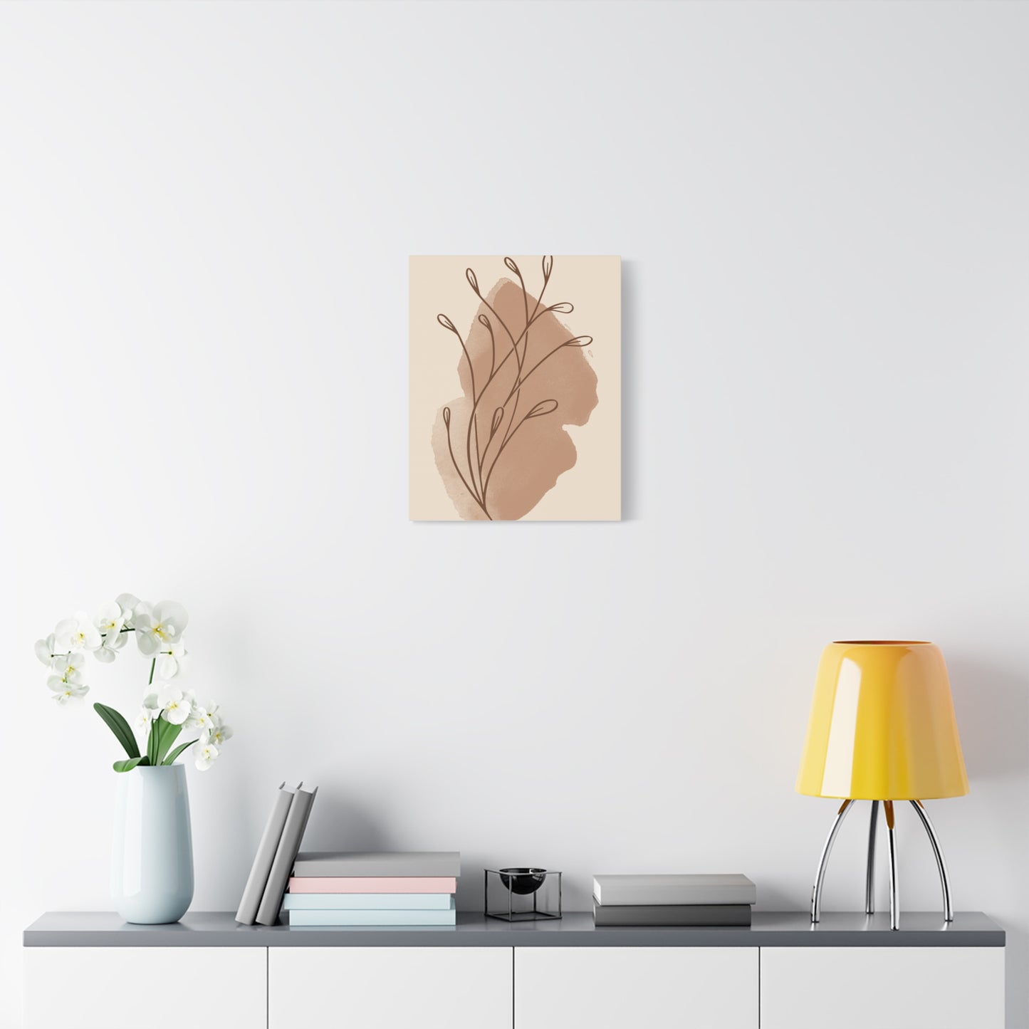 TEEZOCA soft beige abstract leaves canvas framed next to nightstand and lamp.