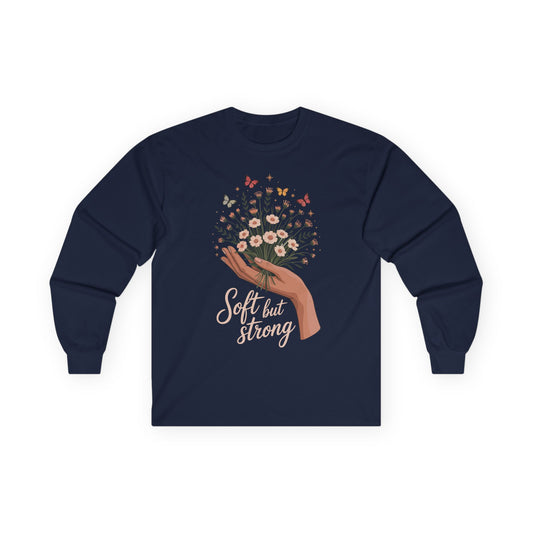 TEEZOCA soft but strong floral artwork on unisex long-sleeve t-shirt Navy blue long-sleeve shirt with floral design and 'Soft but Strong' text on a white background