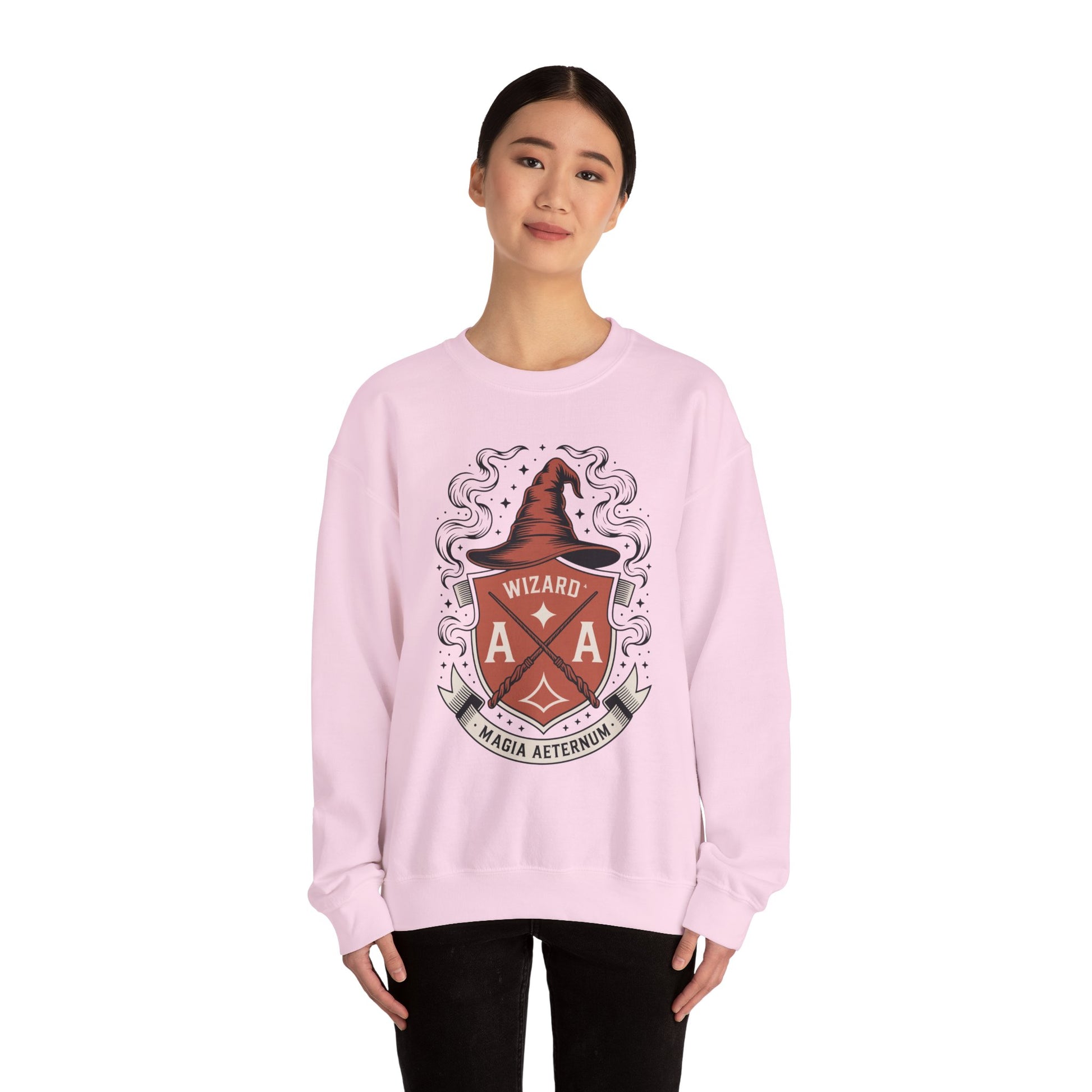 TEEZOCA wizard crest sweatshirt with magical fantasy emblem design Person wearing a pink sweatshirt with a crest design on a white background