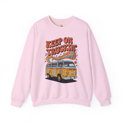 Unisex Heavy Blend crewneck sweatshirt by TEEZOCA with retro van illustration, 70s vibe typography, flowers, and music notes Pink sweatshirt with a graphic of a van and 'Keep on Truckin'' text on a white background