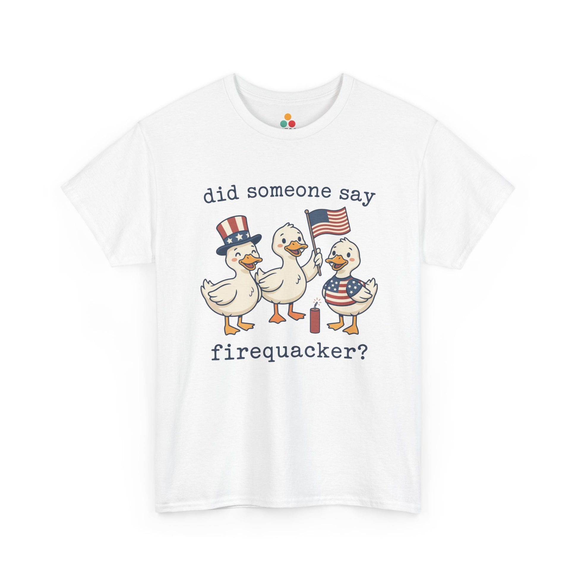 White TEEZOCA T-shirt featuring three cartoon patriotic ducks — one in an Uncle Sam hat, one holding a US flag, and one in a stars-and-stripes outfit — around a firecracker with the text "did someone say firequacker?" printed above and below.

