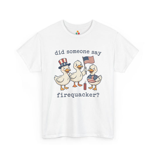 White TEEZOCA T-shirt featuring three cartoon patriotic ducks — one in an Uncle Sam hat, one holding a US flag, and one in a stars-and-stripes outfit — around a firecracker with the text "did someone say firequacker?" printed above and below.

