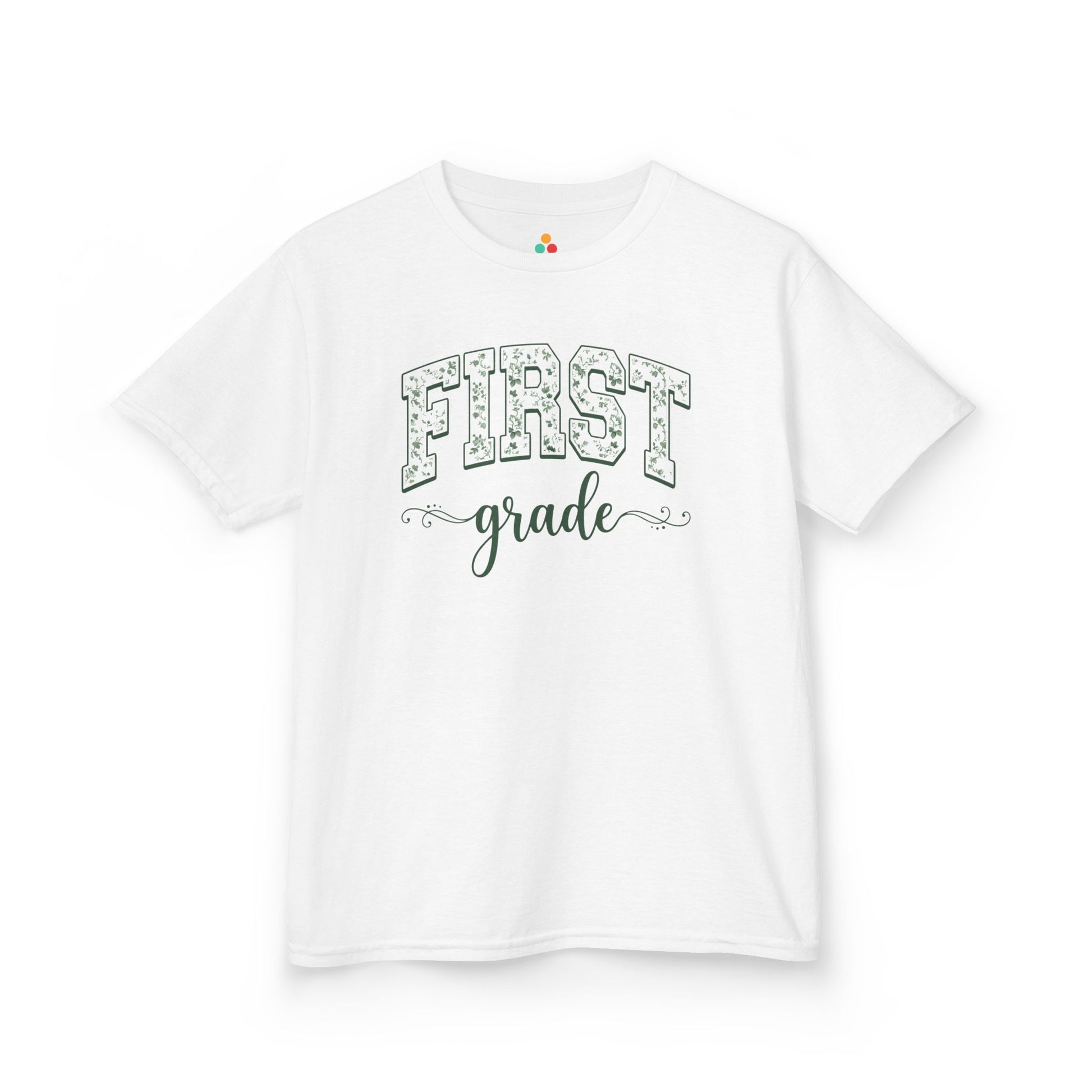 White t-shirt with 'FIRST grade' text on a white background. TEEZOCA floral first grade girl shirt, the kind of kids first-day tee parents shop on Amazon and Etsy for milestone photos.
